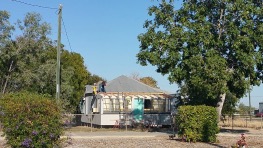 A bit hard to see, but these guys are working a roof without safety lines, worse still they are only about 2 feet away from the power line into the house.